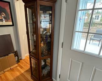 D31 - $85. Lighted Curio Cabinet with adjustable glass shelves. Measures 29" wide x 14" deep x 71" tall. Moves in 1 piece. 