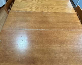 D33 - $175. Drop Leaf Dining Table with 5 Chairs. Measures 38" x 59.25" with drop leaves out x 30.5" tall. Each Drop Leaf is 16". Removable leaf is 14". All pieces are wooden - Chairs could use tightening up. Table top shows some wear. But a solid Vintage Set!