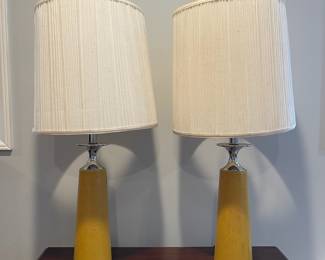 D67 - $30 PAIR of yellow leather wrapped lamps with Chrome accepts.  Leather has scratches/ marks, dents. Shows heavy use. Shades are ok. Measures 30.5" tall. 