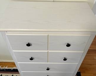 D52 - $50. White Chest of Drawers. Pressed wood - all drawers slide easily. Measures 28" wide x 15.5" deep x 46" tall. 