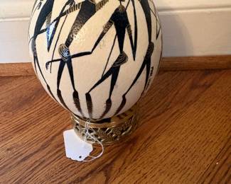 "Bushmen" painted ostrich egg on brass stand/signed