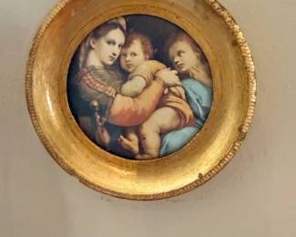 Small framed art depicting the Sistine Madonna
