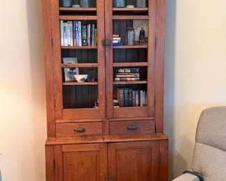 Early bookcase over two door cabinet