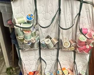 Assorted Spools of Thread and Sewing Notions with Thread Racks