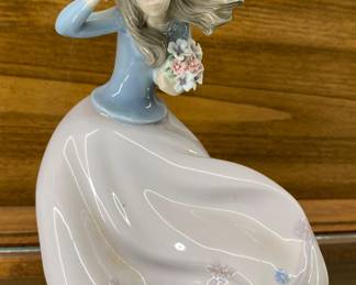 a "Blustery Day" porcelain figurine made by Lladró