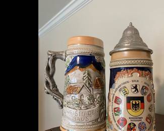 two German beer steins, specifically identified as a Wiesbaden Haus stein and a Bundesrepublik Deutschland coat of arms stein
