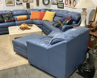 Light blue leather sectional, matching chair and ottoman, more art work, throw pillows