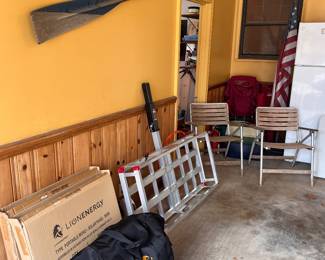 Solar panels and generator, cargo rack, vintage folding chairs, flag on stand, tackle box, 1960’s high school rowing oar