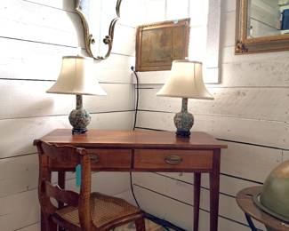 Antique writing desk or library table, Chinoiserie-style ginger jar lamps, Cane-bottom chair