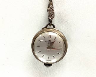 VTG. BUCHERER LADIES SILVER ORB COCKTAIL WATCH THIS SWISS MADE 17 JEWEL SKELETON BACK ORB PENDANT WATCH IS IN 800 SILVER CASE WITH 28 INCH 800 SILVER CHAIN. THE WATCH MECHANISM IS RUNNING.