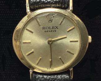 ROLEX GENEVE 14KT YELLOW GOLD LADIES WRISTWATCH, 17 JEWEL SWISS MOVEMENT, BLACK LEATHER BAND, CRYSTAL HAS A SMALL SCRATCH, GOOD WORKING CONDITION, WITH GREEN SUEDE ROLEX POUCH