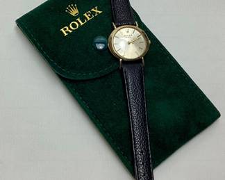 ROLEX GENEVE 14KT YELLOW GOLD LADIES WRISTWATCH, 17 JEWEL SWISS MOVEMENT, BLACK LEATHER BAND, CRYSTAL HAS A SMALL SCRATCH, GOOD WORKING CONDITION, WITH GREEN SUEDE ROLEX POUCH