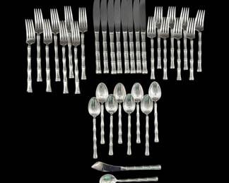 Eight piece place setting of sterling silver flatware by Towle in "Mandarin" pattern includes 8 dinner forks (432g.), 8 salad forks (352g.), 8 knives, 8 teaspoons (298g.), plus one sugar spoon (36g.) and one master butter knife.