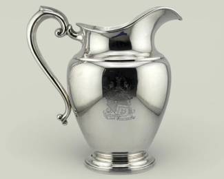 Sterling silver pitcher is engraved with armorial shield with the words "Justum Perficito/Nihil Timeto" (Act justly, fear nothing). It is marked P.S. Co. (probably Poole Silver, Taunton, MA) and sterling on bottom; 9"W x 9"H, 723g.