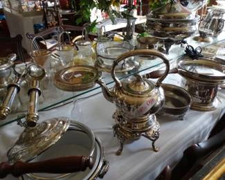 There's a table full of ine Silverplate Holoware