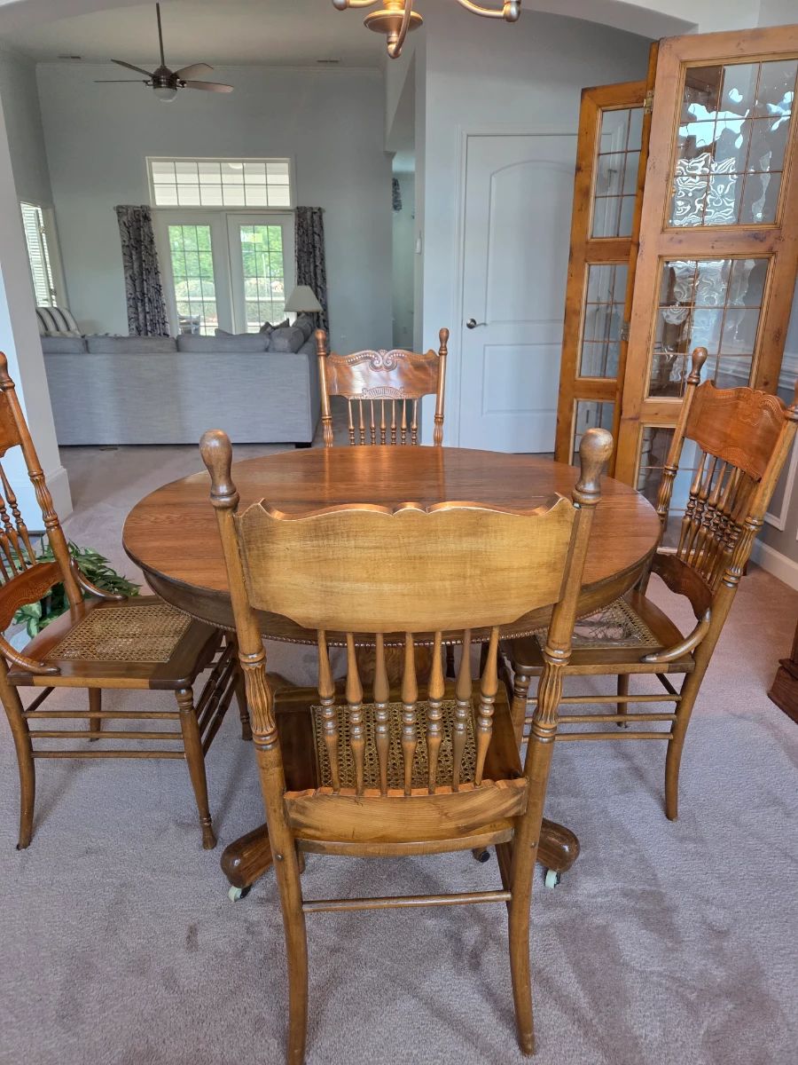 Antique table with 4 cane seat chairs.