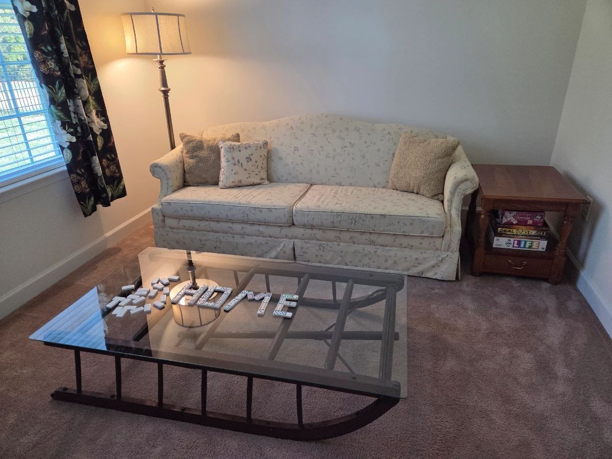 Antique sleigh table, flexsteel couch, end table and floor lamp