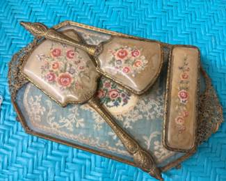 Vintage or antique petit point needlepoint vanity set, includes mirror, hairbrush, clothes brush with embroidered floral designs on filigree tray