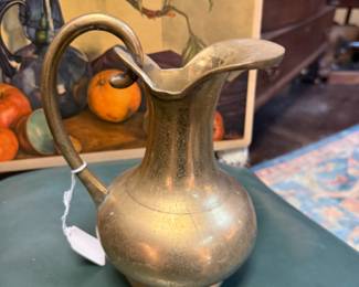 Vintage brass water pitcher with rounded body, pronounced pouring spout and curved handle 