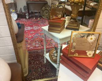 Beautiful gold framed wall mirror, vintage books, end table