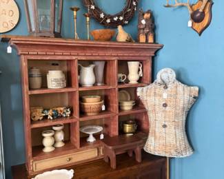 wicker dress form, pretty crocks, small pitchers, cake stand, wooden candlesticks, vintage stool, vintage table