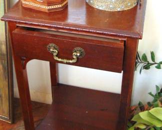 Small, square nightstand with drawer, and other items (items sold separately).