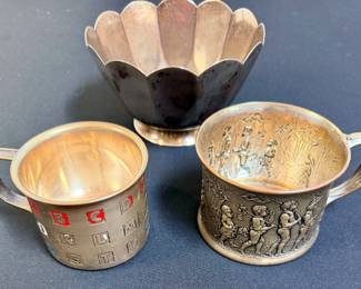 Tiffany & Co. sterling silver bowl (top) and silver mugs (bottom)