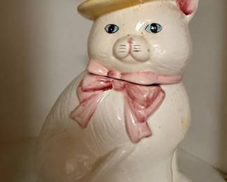 Vintage ceramic cat cookie jar with straw hat and pink bow