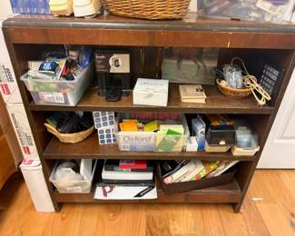 Wooden bookshelf with Oxford dictionary, vintage camera, office supplies lot