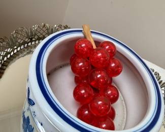 Blue and white ceramic canister with red berry lid, decorative kitchen jar