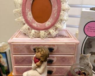 Pink jewelry box with lace trim and oval mirror, ceramic figurine, coin jar