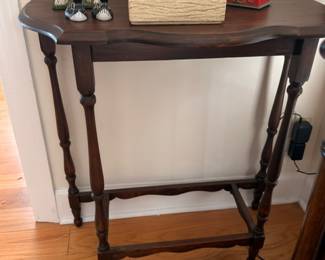 Antique dark wood console table with turned legs and stretcher
