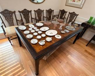 Antique dark wood dining table with carved Chippendale-style chairs, china set