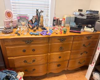 Oak 9-drawer dresser with collectible figurines, vintage toys, electronics, household items