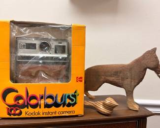 Kodak Colorburst instant camera in original box, carved wooden horse figurine