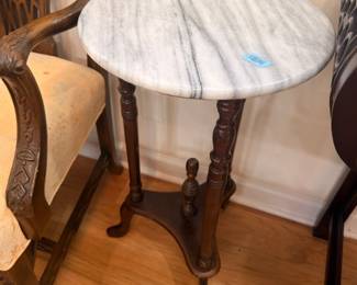 Victorian marble-top round parlor table with carved dark wood base