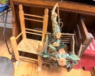 Wooden ladder back chair with dried floral arrangement, household items