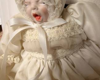 Vintage porcelain baby doll in white christening gown and bonnet