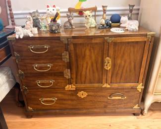 Vintage dark wood sideboard cabinet with brass pulls, collectible figurines