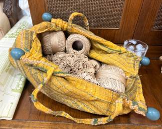 Vintage sewing bag with spools of thread, twine, and craft supplies