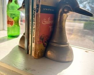 Brass duck head bookends, vintage books, green glass soda bottle