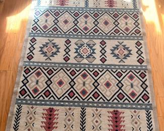Southwestern Native American style woven area rug with geometric design and fringe