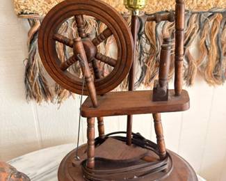 Vintage miniature decorative spinning wheel on wooden base