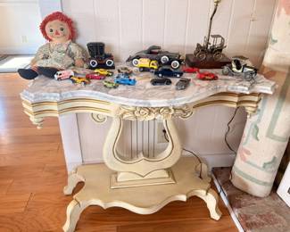 Vintage Raggedy Ann doll, die-cast model cars, marble-top lyre base console table