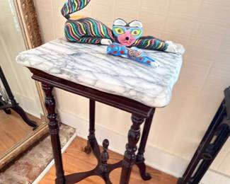 Victorian marble-top side table with carved wood base, art glass bird figurine