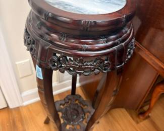 Antique carved marble-top plant stand, detail view of ornate legs and fretwork