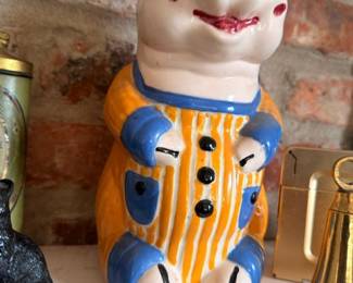 Vintage ceramic pig cookie jar in blue overalls