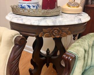 Victorian marble-top parlor table with brass candlestick, cranberry glass, blue and white china