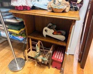 Wooden desk with vintage toys, rocking horse, collectibles, and household items