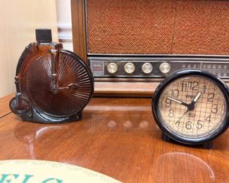 Vintage round alarm clock, antique tube radio, amber glass shell dish